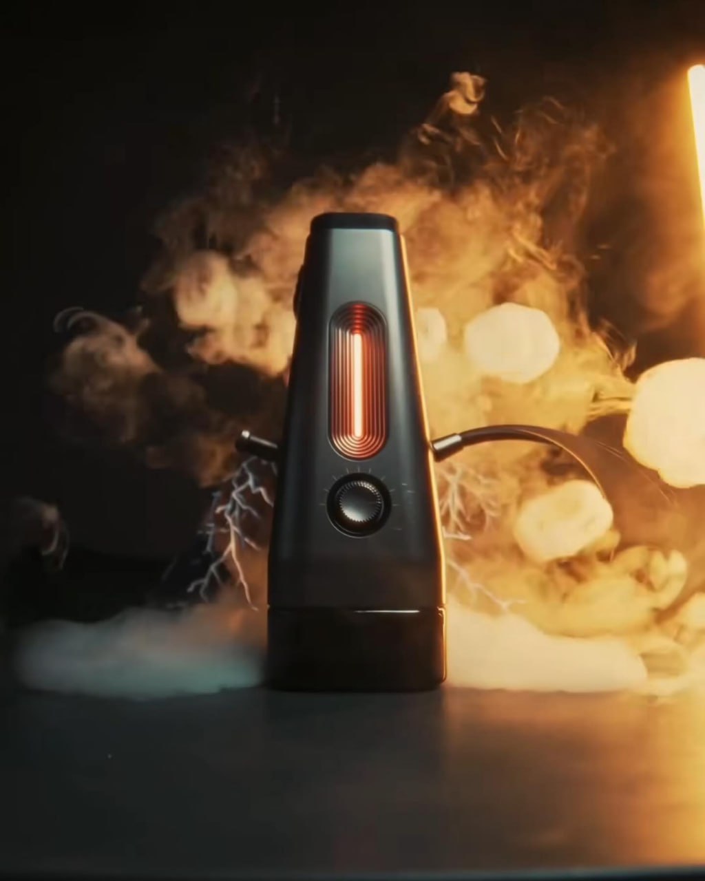 The Enso electric hookah in action, surrounded by thick smoke and dramatic lighting. If you're ready to ditch charcoal entirely, this is easily the best hookah pipe for a futuristic, portable session.