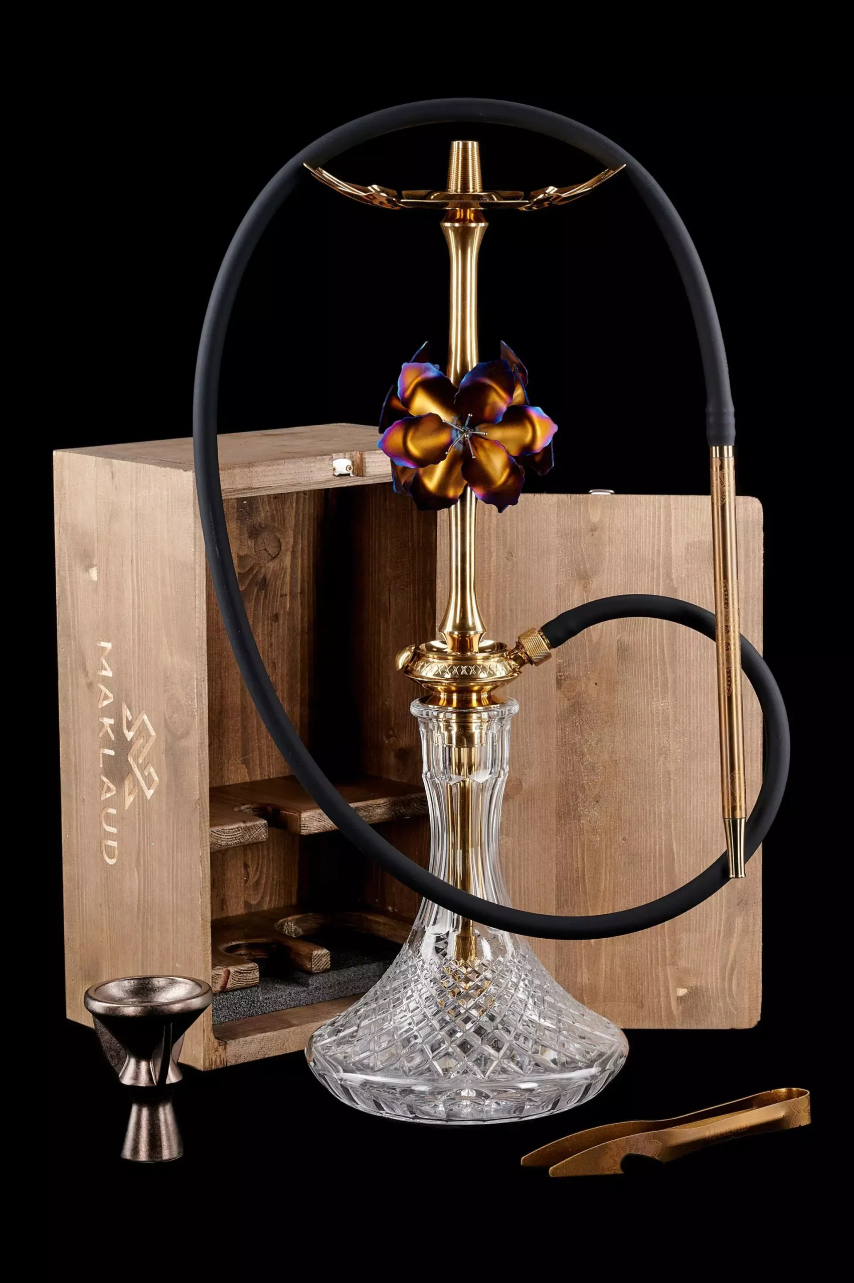The luxurious Maklaud Lily Gold alongside its custom wooden box. Definitely the best hookah pipe for anyone wanting a high-end, statement centerpiece.