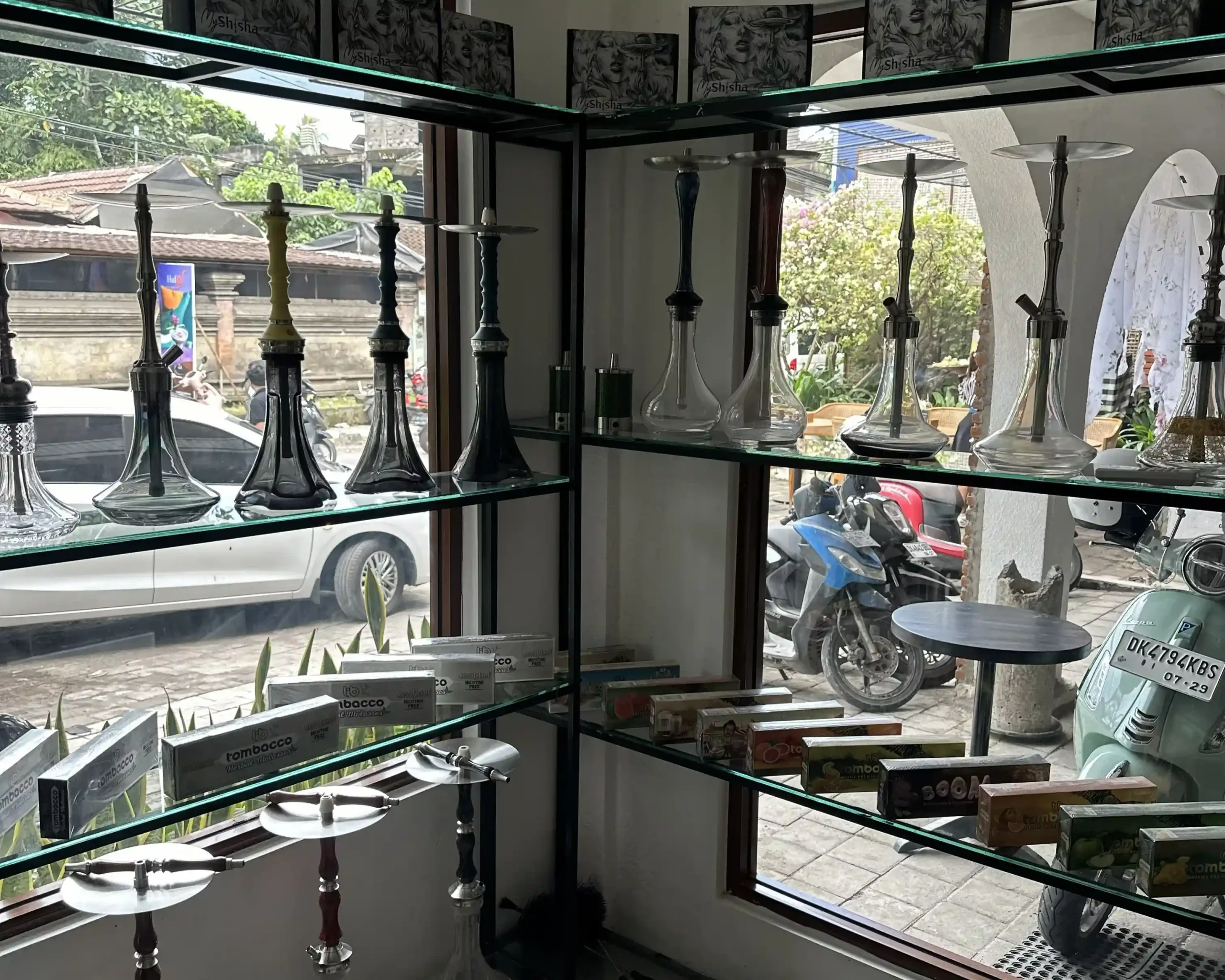 The MyShisha retail display inside Eden Hookah Club Ubud, featuring glass shelves of hookahs and tobacco—a highly recommended spot to buy shisha in Bali.