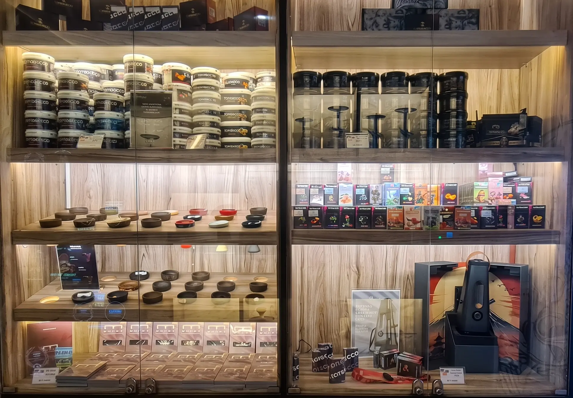A neat glass retail cabinet at Eden Hookah Club Seminyak stocked with premium hookah bowls and tobacco, making it easy to buy shisha in Bali on the go.